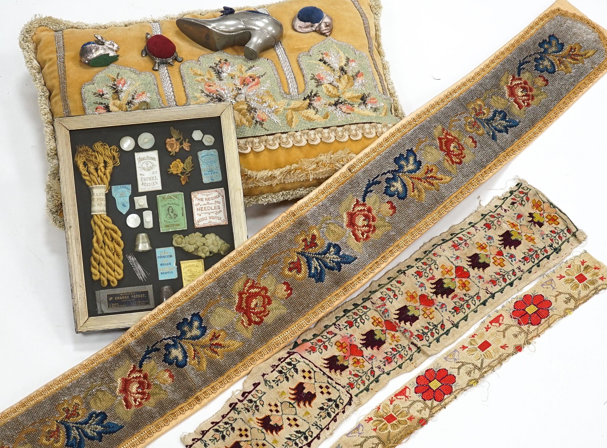 A Berlin bead worked bell pull, a similar cushion, two panels of Turkish embroidery, a framed sewing related collage and four animal pin cushions